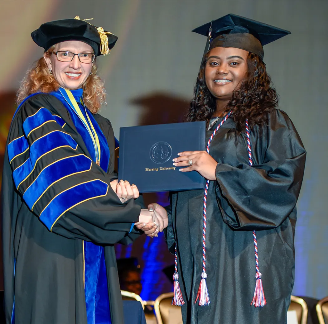 Herzing graduate receiving her diploma