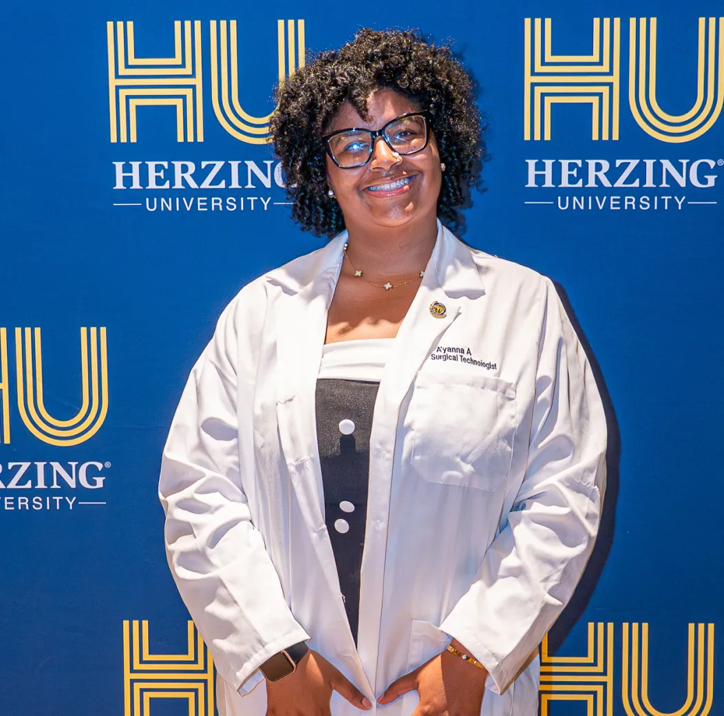 Surgical technology student in a white coat