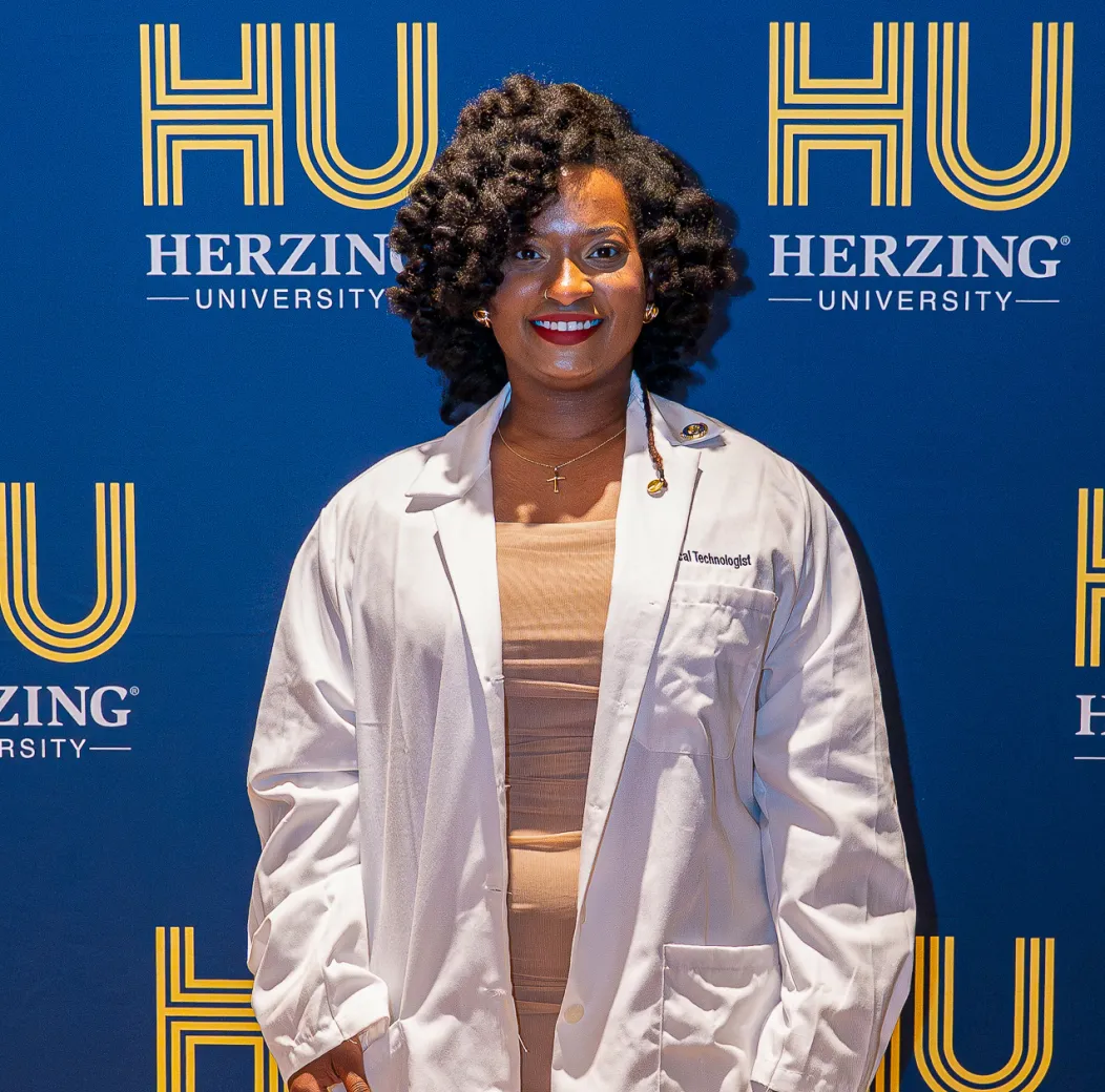 Surgical technology student in a white coat