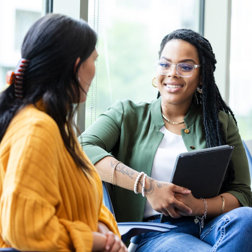Counselor and client engaged in a supportive behavioral health conversation.